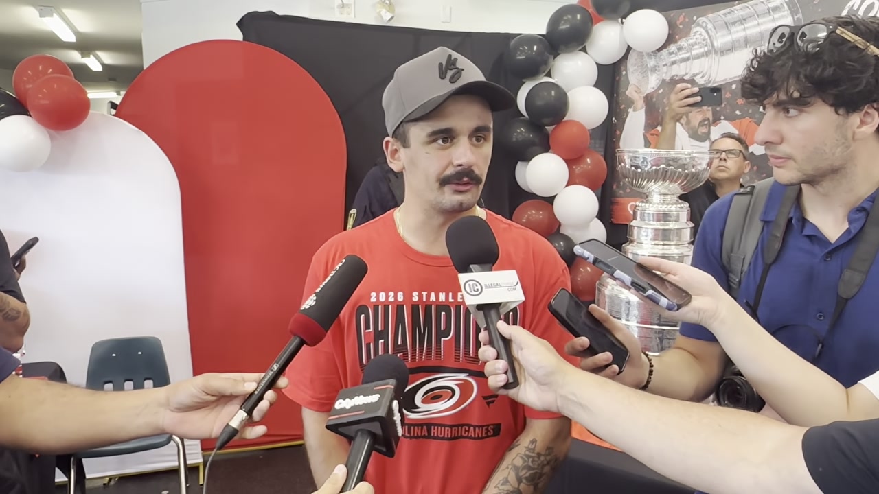 Seth Jarvis wears a 2026 Stanley Cup champions shirt while speaking to reporters during his day with the Cup in Winnipeg