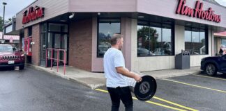 Taylor Hall Stanley Cup Day: Tim Hortons and a Muskoka Cruise Taylor Hall carries the Stanley Cup outside a Tim Hortons in Bracebridge, Ontario during his day with the Cup