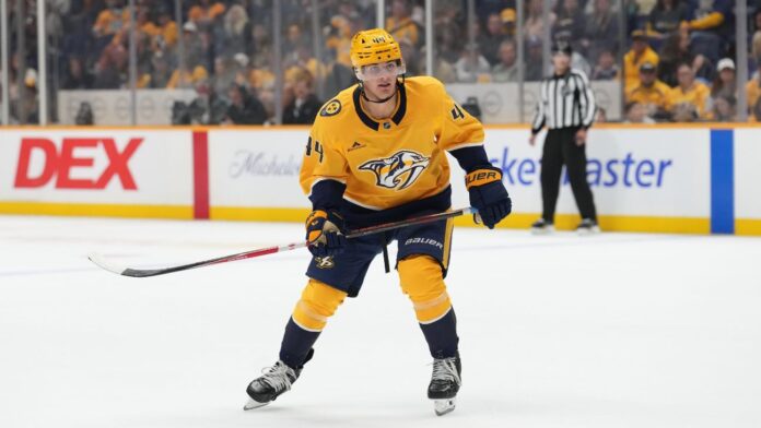 brady-martin-predators-action Brady Martin skates in Nashville Predators gold jersey during NHL action