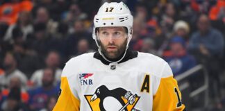 Bryan Rust Injury: Penguins Winger Exits Preseason Finale Bryan Rust in Pittsburgh Penguins white road jersey wearing the A