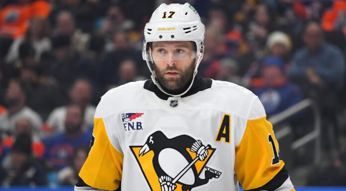 Bryan Rust Injury: Penguins Winger Exits Preseason Finale Bryan Rust in Pittsburgh Penguins white road jersey wearing the A