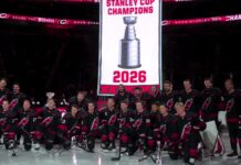 Hurricanes Raise Stanley Cup Banner Before Panthers Opener Carolina Hurricanes pose for a team photo under their 2026 Stanley Cup champions banner at Lenovo Center before the season opener against the Florida Panthers