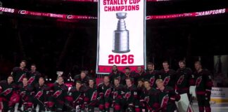 Hurricanes Raise Stanley Cup Banner Before Panthers Opener Carolina Hurricanes pose for a team photo under their 2026 Stanley Cup champions banner at Lenovo Center before the season opener against the Florida Panthers