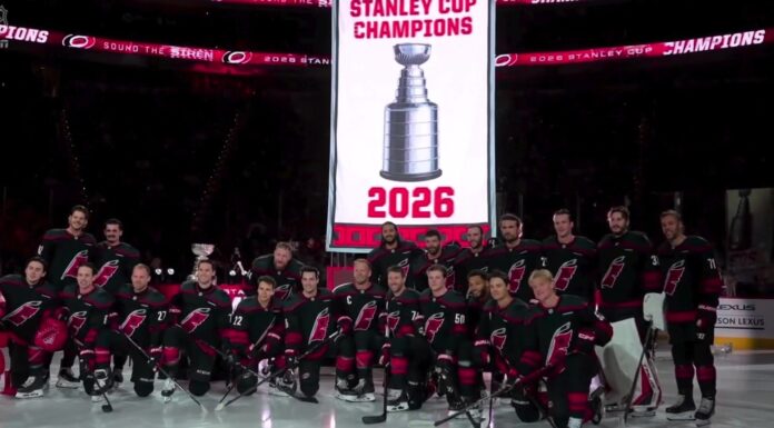 Hurricanes Raise Stanley Cup Banner Before Panthers Opener Carolina Hurricanes pose for a team photo under their 2026 Stanley Cup champions banner at Lenovo Center before the season opener against the Florida Panthers