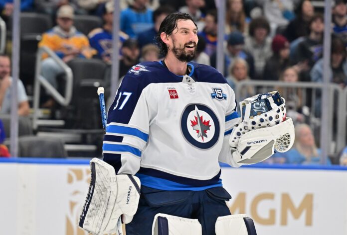 Connor Hellebuyck Jets trade request training camp Winnipeg Jets goaltender Connor Hellebuyck during a timeout against the St. Louis Blues