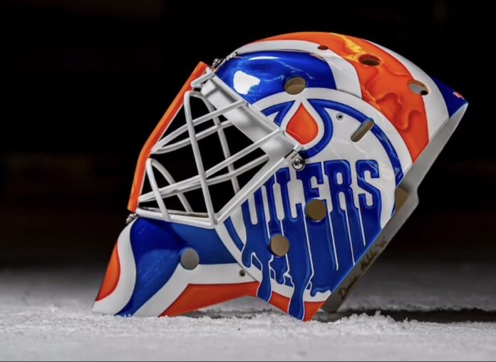 Devon Levi Oilers goalie mask 2026-27 side Side view of Devon Levi's 2026-27 Oilers goalie mask with dripping OILERS wordmark