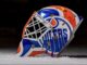 Devon Levi Injured Reserve: Oilers Recall Matt Tomkins Side view of Devon Levi's 2026-27 Oilers goalie mask with dripping OILERS wordmark