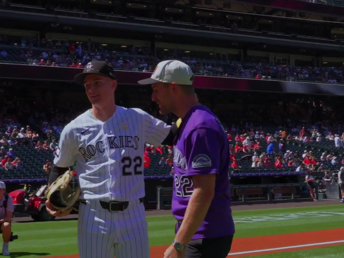 Devon Toews poses with Rockies outfielder Mickey Moniak after his first pitch at Coors Field
