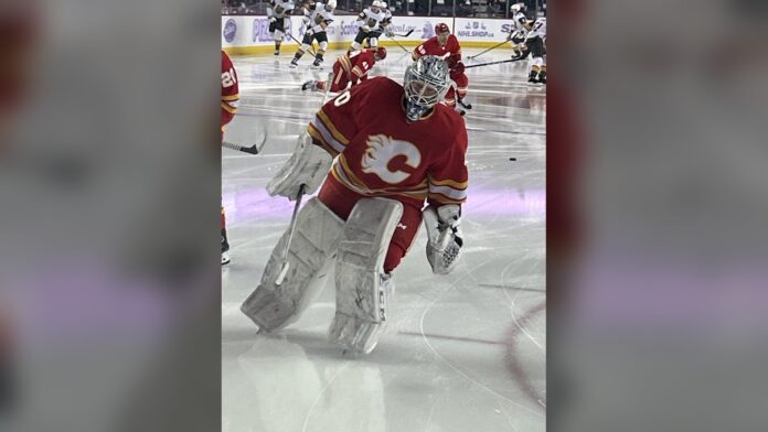 Dusty Nickel Flames EBUG 2026-27 Dusty Nickel in Calgary Flames goalie gear during warmups as the Flames name him their full-time emergency backup goaltender EBUG for 2026-27
