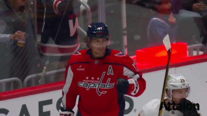 dylan-strome-goal-capitals-bruins-preseason Dylan Strome celebrates a goal for the Washington Capitals in a red home jersey against the Boston Bruins