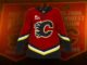 Flames Throwback Jersey: 2004 Black C Back for Dome Finale Calgary Flames 2004 throwback alternate jersey with black Flaming C crest hanging in front of Saddledome banners