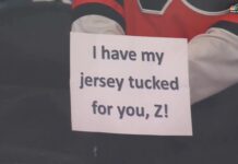 Flyers Tuck Jerseys in Warmup Protest of Zegras Penalty Flyers player holds up sign reading I have my jersey tucked for you Z during warmups referencing Trevor Zegras jersey tuck penalty