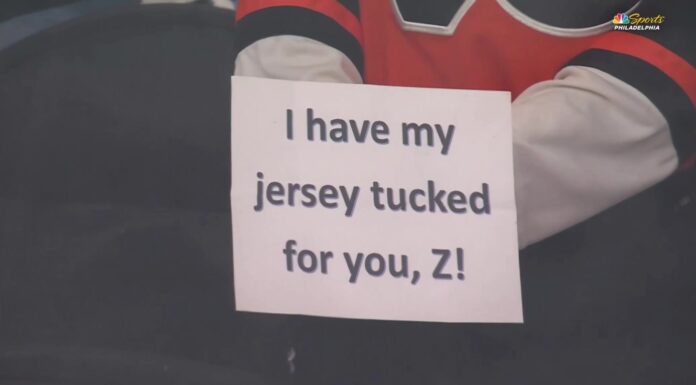 Flyers Tuck Jerseys in Warmup Protest of Zegras Penalty Flyers player holds up sign reading I have my jersey tucked for you Z during warmups referencing Trevor Zegras jersey tuck penalty