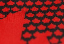 Hockey Canada Jersey Reveal Set for Sept. 9 After Teaser Hockey Canada new jersey teaser showing black maple leaves on a red base ahead of the 2027 World Juniors