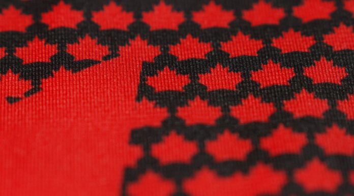 Hockey Canada Jersey Reveal Set for Sept. 9 After Teaser Hockey Canada new jersey teaser showing black maple leaves on a red base ahead of the 2027 World Juniors