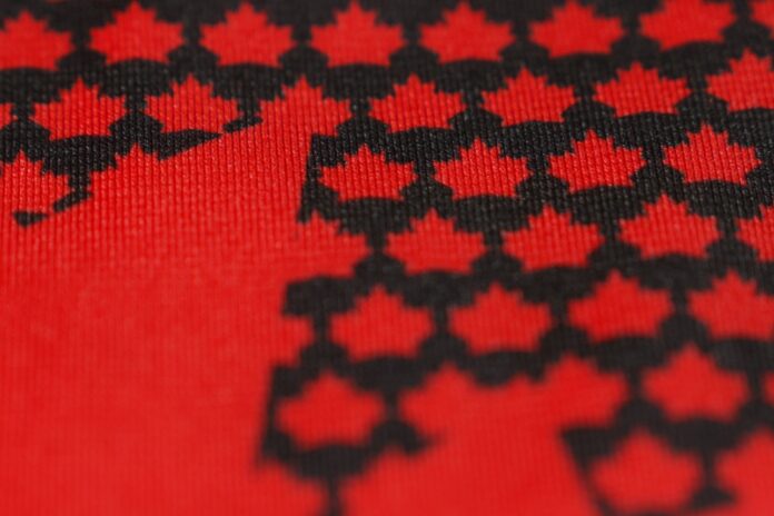 Hockey Canada new jersey teaser red maple leaf Hockey Canada new jersey teaser showing black maple leaves on a red base ahead of the 2027 World Juniors