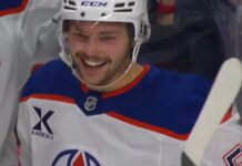 Isaac Howard celebrates his first NHL goal on the Edmonton Oilers bench