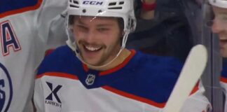 Isaac Howard celebrates his first NHL goal on the Edmonton Oilers bench