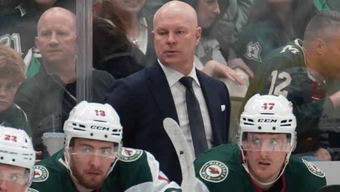 John Hynes Minnesota Wild head coach behind the bench Minnesota Wild head coach John Hynes watches from behind the bench