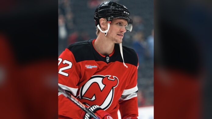 Nick Bjugstad New Jersey Devils injury 2026 New Jersey Devils forward Nick Bjugstad in a red Devils jersey during warmups