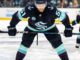Shane Wright of the Seattle Kraken lines up for a faceoff at Climate Pledge Arena