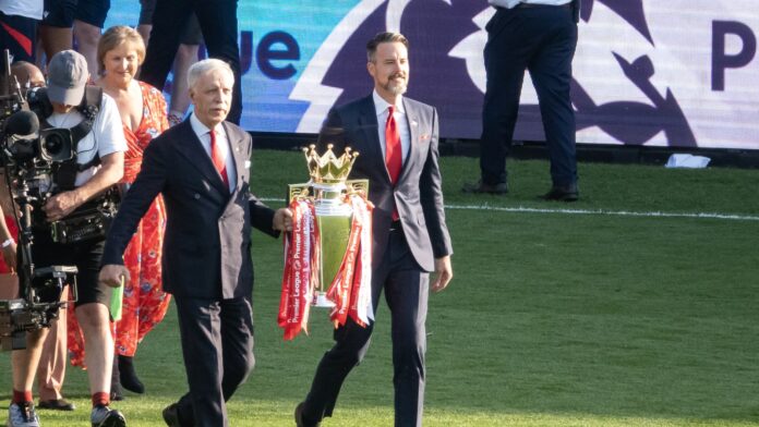 Stan Kroenke and Josh Kroenke Premier League trophy 2026 Avalanche owner Stan Kroenke and Josh Kroenke carry the Premier League trophy in May 2026