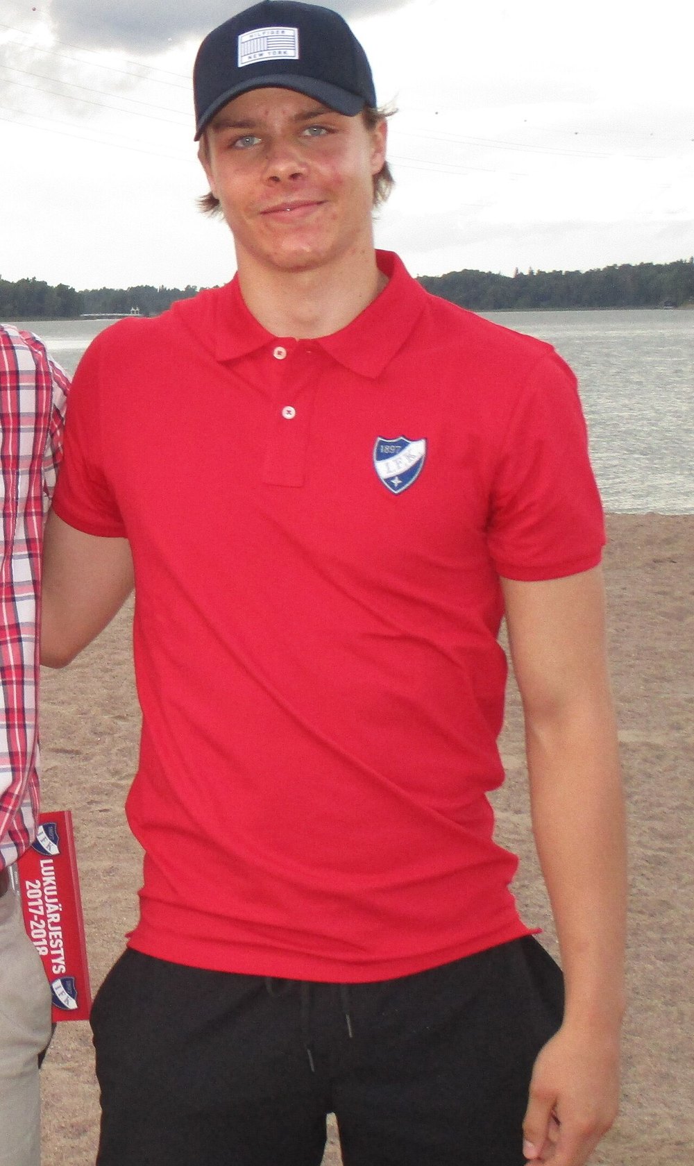A teenage Miro Heiskanen in an HIFK polo shirt at a team event on a Helsinki beach