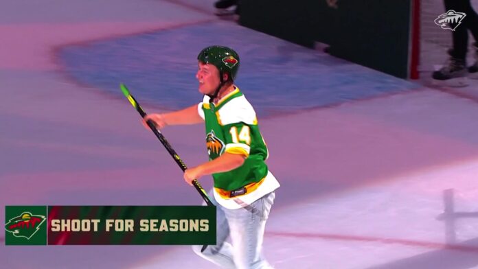 Minnesota Wild fan celebrates center ice shot to win season tickets Minnesota Wild fan in a green Joel Eriksson Ek throwback jersey celebrates after scoring from center ice during the Shoot for Seasons contest at Grand Casino Arena