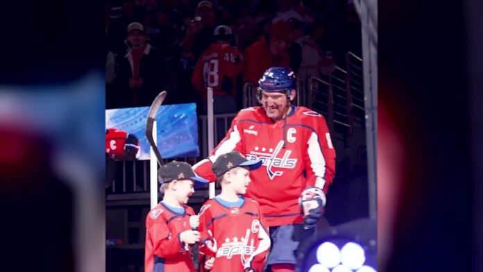 Alex Ovechkin sons Sergei Ilya Capitals home opener introduction Alex Ovechkin with sons Sergei and Ilya after they introduced him at the Capitals 2026-27 home opener at Capital One Arena