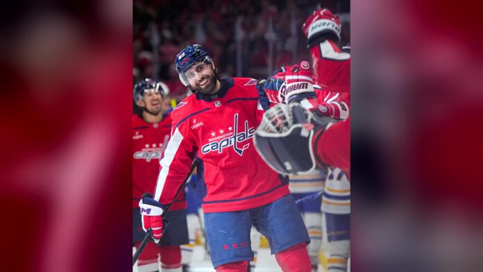 Alex Tuch Capitals goal celebration vs Sabres Alex Tuch smiling while celebrating a goal with Capitals teammates against the Buffalo Sabres