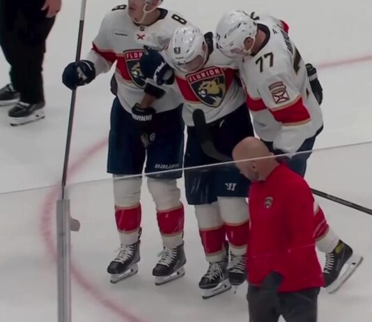 Brad Marchand helped off the ice by Panthers teammates Brady Tkachuk and Niko Mikkola after a lower-body injury against the Kings