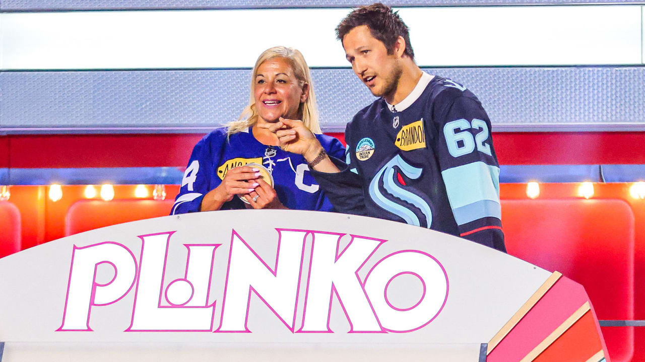 Brandon Montour helps a contestant at the Plinko board on The Price Is Right Tonight