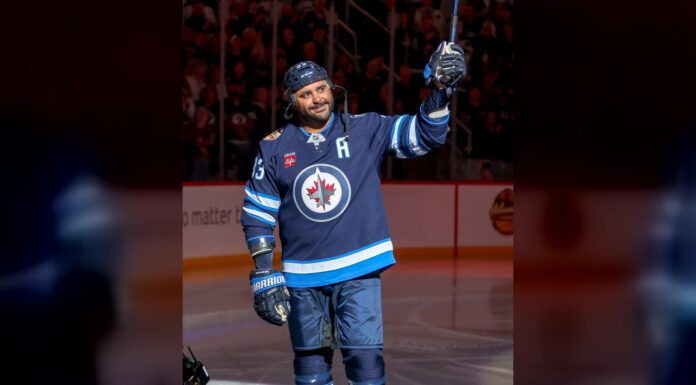 Byfuglien Message: Winnipeg Gave Him a Goodbye He Never Got Dustin Byfuglien raises his stick to the crowd in a Winnipeg Jets sweater during the Jets alumni game