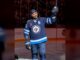 Byfuglien Message: Winnipeg Gave Him a Goodbye He Never Got Dustin Byfuglien raises his stick to the crowd in a Winnipeg Jets sweater during the Jets alumni game