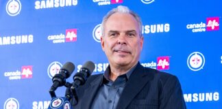 Cheveldayoff Hellebuyck Trade: Wishes It Happened Sooner Winnipeg Jets GM Kevin Cheveldayoff at podium discussing Connor Hellebuyck trade to Devils