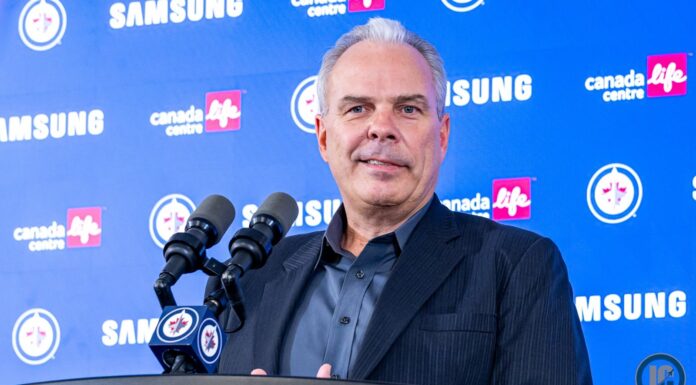Cheveldayoff Hellebuyck Trade: Wishes It Happened Sooner Winnipeg Jets GM Kevin Cheveldayoff at podium discussing Connor Hellebuyck trade to Devils