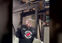 Hellebuyck Suspension Lifted: Devils Carry $8.1M Cap Hit Connor Hellebuyck in Devils practice jersey and goalie mask stepping onto the ice in New Jersey