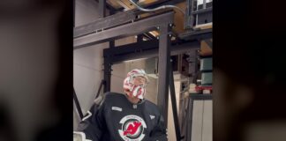 Hellebuyck Suspension Lifted: Devils Carry $8.1M Cap Hit Connor Hellebuyck in Devils practice jersey and goalie mask stepping onto the ice in New Jersey