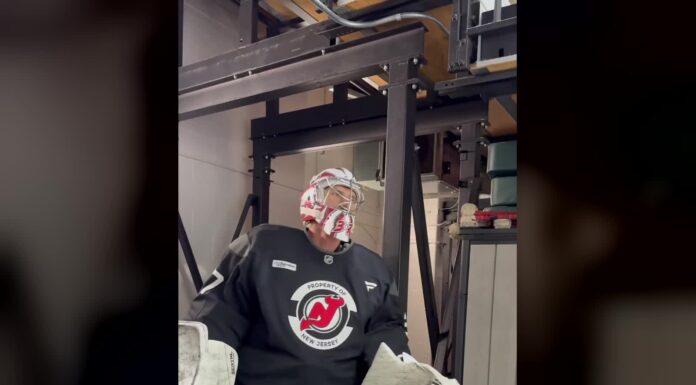 Hellebuyck Suspension Lifted: Devils Carry $8.1M Cap Hit Connor Hellebuyck in Devils practice jersey and goalie mask stepping onto the ice in New Jersey
