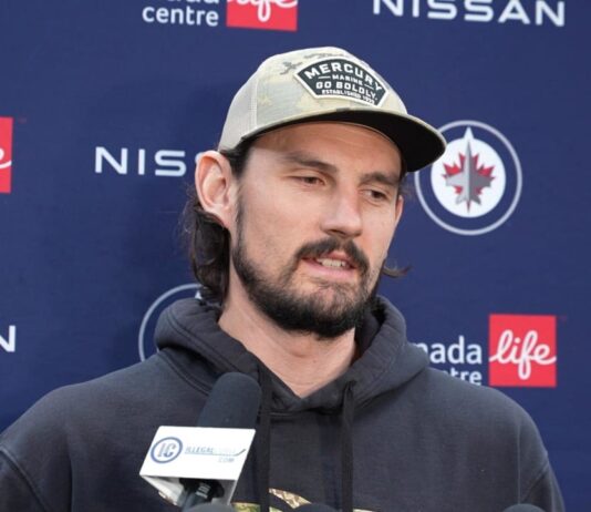 Connor Hellebuyck speaks to media at a Winnipeg Jets press conference