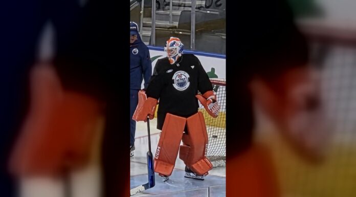 Oilers Hometown Remix Jersey: Black Gear Shows at Practice Oilers goalie Devon Levi in bright orange pads and black practice jersey at Rogers Place