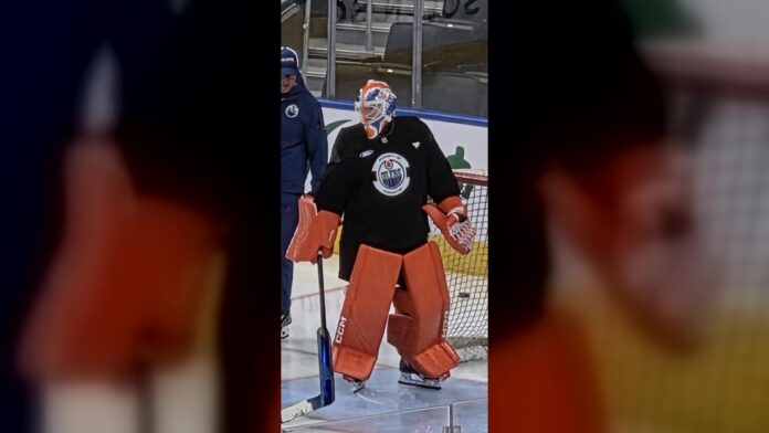 Devon Levi Oilers orange goalie pads Hometown Remix practice Oilers goalie Devon Levi in bright orange pads and black practice jersey at Rogers Place