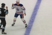 Trent Frederic Oilers and Jack McBain Mammoth square up with fists raised before first period fight