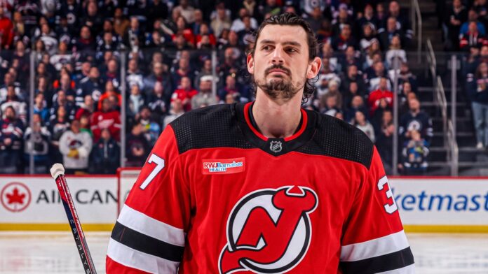 Hellebuyck Devils trade details Connor Hellebuyck in a New Jersey Devils jersey after the Jets-Devils trade