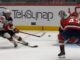 Tom Wilson Hit: Jack Hughes Bails Out Before Contact Jack Hughes Devils shoots backhand as Tom Wilson Capitals closes in during Devils-Capitals game