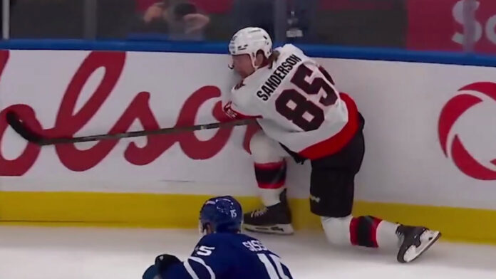 Jake Sanderson injury Senators vs Maple Leafs Senators defenseman Jake Sanderson down along the boards after getting tangled up with Nick Paul in the season opener against the Maple Leafs
