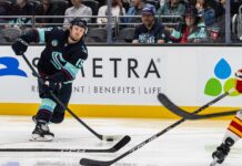 Jared McCann Injury: Kraken Forward Out 10 Weeks on IR Jared McCann Kraken forward shooting puck against Flames