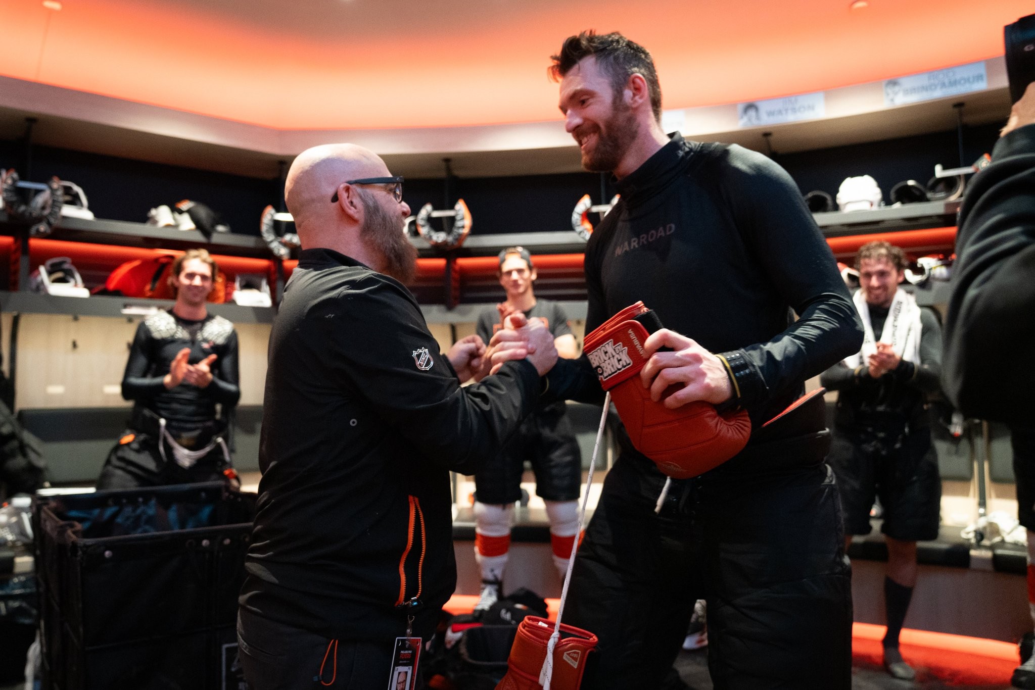 Sean Couturier presents Rocky gloves to Flyers broadcaster Jason Myrtetus