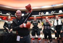 Tocchet Game Puck: Flyers Coach Honors Jason Myrtetus Jason Myrtetus Flyers radio broadcaster holding Rocky gloves in locker room