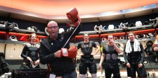 Tocchet Game Puck: Flyers Coach Honors Jason Myrtetus Jason Myrtetus Flyers radio broadcaster holding Rocky gloves in locker room
